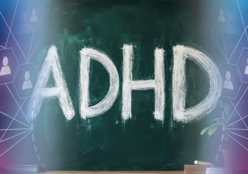 Vectored ADHD image The letters 'ADHD' written in chalk across a dark green blackboard, with soft gradient lighting and abstract human-network icons faintly visible behind—suggesting a focus on neurodiversity and awareness of ADHD